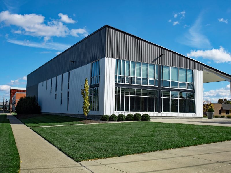 Modern industrial building with large windows and clear sky.